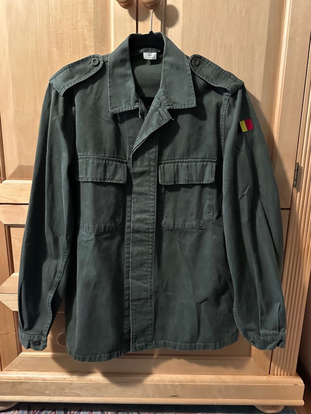 This is a military-style jacket by Michelsens, a Belgian flag patch 52L